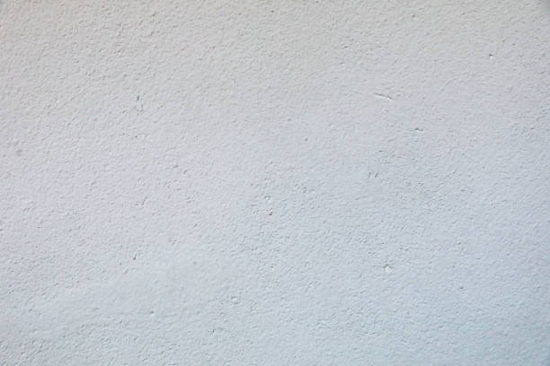 istock Light gray textured wall with small holes 1347398246