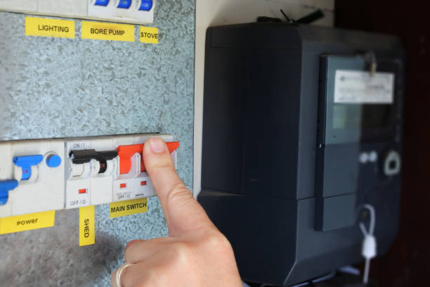 istock Person pressing the main electric power button on 1347398343