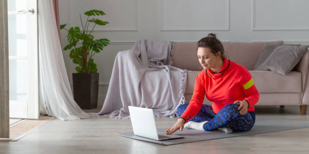 Vertical photo of a middle aged woman prepares for online workout. Format photo 2x1 stock photo