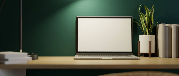 istock Modern home workspace at night with laptop screen mockup and decor on wooden table over green wall. 1347403828