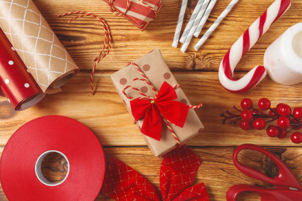 istock Christmas wrapping and decorating items on wooden background with copy space 1347405006
