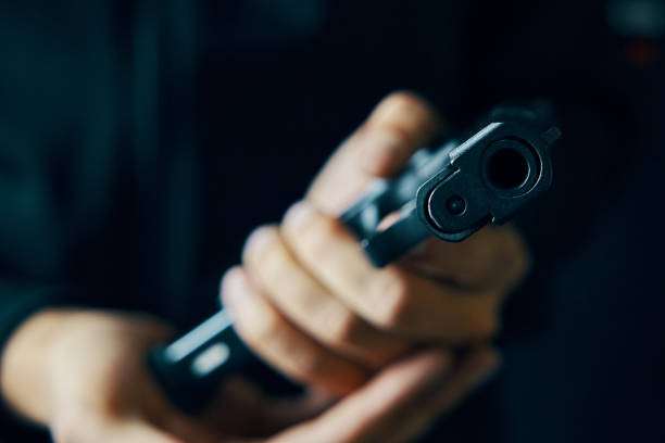 istock Close up of man reloading pistol. 1347405343