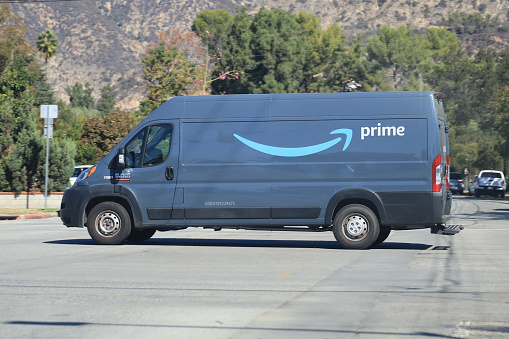 Pasadena, California, USA - October 17, 2021: Amazon Delivery truck making deliveries on Sunday in Pasadena, California.