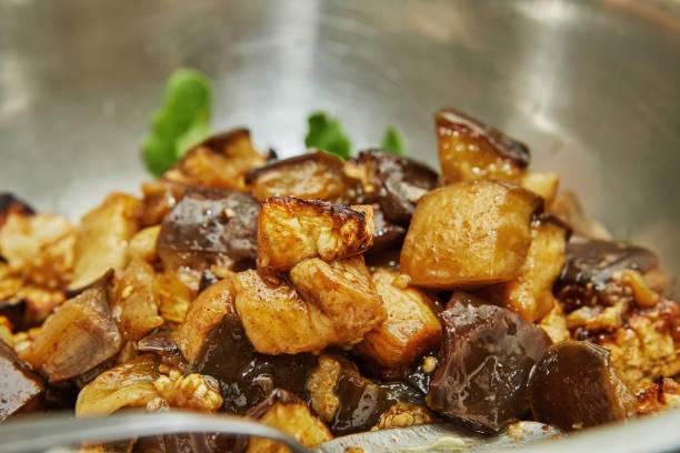 istock Baked, diced eggplant in bowl of arugula. Step by step recipe 1347406752