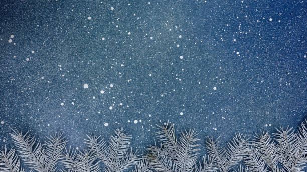 istock christmas tree branches on blue background. new year holiday background with copy space. 1347409177