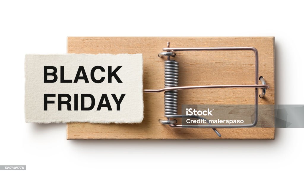 Black Friday word on mouse trap Paper note with Black Friday written on it on a mousetrap isolated on white background. Black Friday - Shopping Event Stock Photo