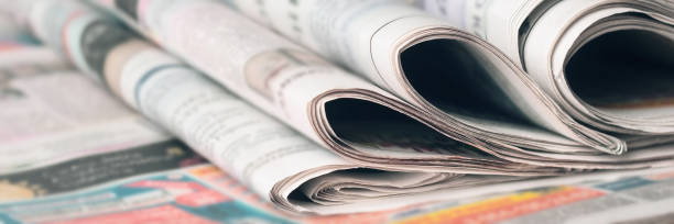 panoramic image of old newspapers. blur, selective focus. - press release imagens e fotografias de stock