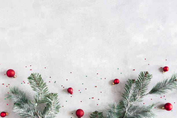 istock Christmas composition. Fir tree branches, red decorations on gray background. Christmas, winter, new year concept. Flat lay, top view, copy space 1347411449