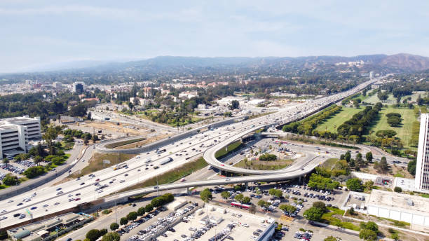 West Los Angeles and view to San Fernando valley along interstate freeway 405 - aerial view Aerial view of West  Los Angeles towards san Fernando valley, with traffic on the 405 Freeway highway 405 photos stock pictures, royalty-free photos & images