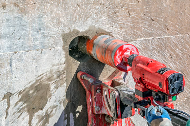istock Worker is drilling to concrete wall with core drill machine. Core drills used in metal are called annular cutters. Core drills used for concrete and hard rock generally use industrial diamond grit. 1347412860