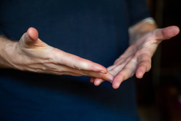 istock both hands of caucasian man in dark background 1347416494