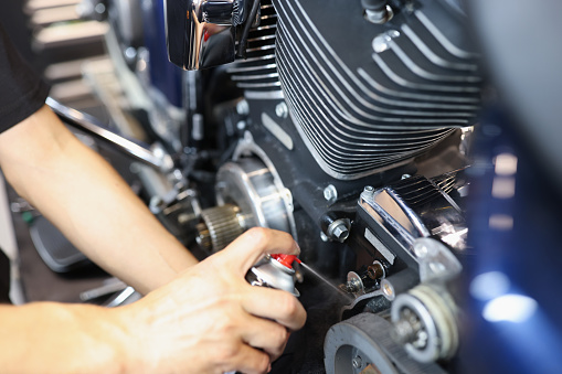 Engine Puff Master Locksmith Puffs Liquid On Motorcycle Engine In Garage Closeup ...