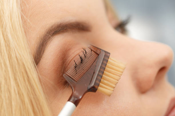 istock Woman brushing her eyelashes 1347416834