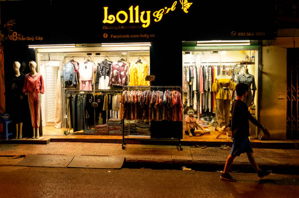 Family trade in women's clothing open late at night Hanoi, Vietnam; September 16, 2018: Family trade in women's clothing open late at night vietnamese girls for sale stock pictures, royalty-free photos & images