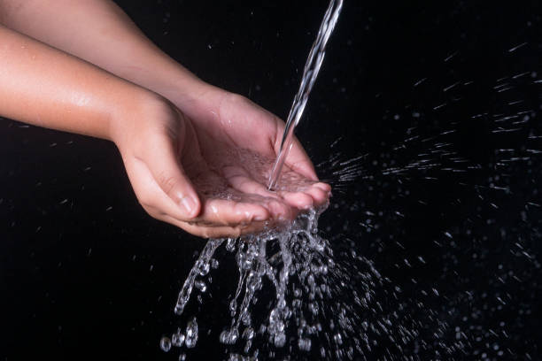 istock Pouring water splashing on hand 1347418863