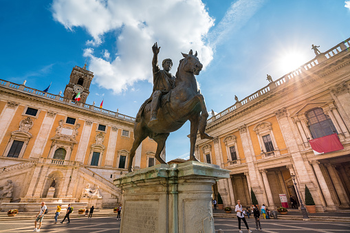 Rome, Italy, October 16 -- A view of the majestic equestrian statue of Emperor Marcus Aurelius, located in the center of Piazza del Campidoglio (the Roman Capitol Square) on the Capitoline Hill, square designed by Michelangelo in 1534 in the historic heart of Rome. In the background, the ancient Palazzo Senatorio, seat of the municipal government of the Eternal City. The original statue of Marcus Aurelius is kept inside the Capitoline Museums. In 1980 the historic center of Rome was declared a World Heritage Site by Unesco. Image in high definition format.