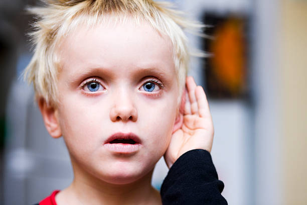 Boy cupping ear What was that? deaf stock pictures, royalty-free photos & images