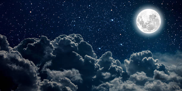 istock backgrounds night sky with stars and moon and clouds. 1347422313