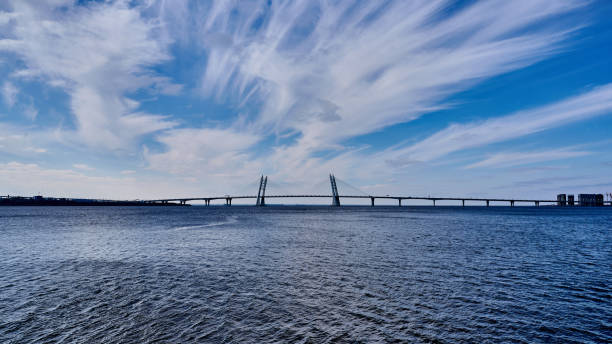 istock Cable-stayed bridge across the Neva River against the blue sea and sky with clouds 1347423943