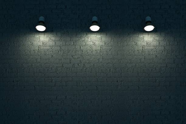 istock Three wall lamps hang on a dark brick wall. Light lighting, isolated dark background. 3D graphics. Interior design 1347426076