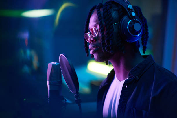 istock African man recording a song in the studio 1347426624