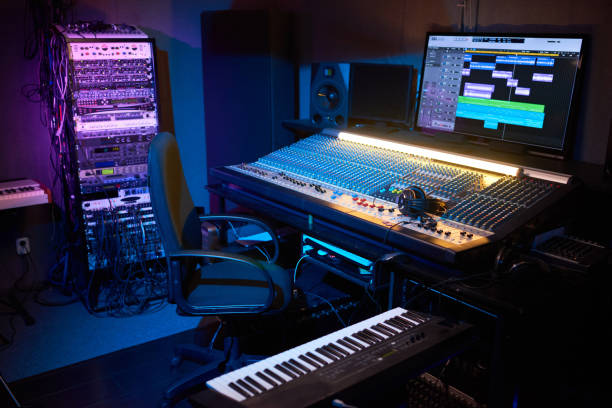 Modern recording studio with computer Image of modern dark recording studio with computer and musical instruments recording studio stock pictures, royalty-free photos & images