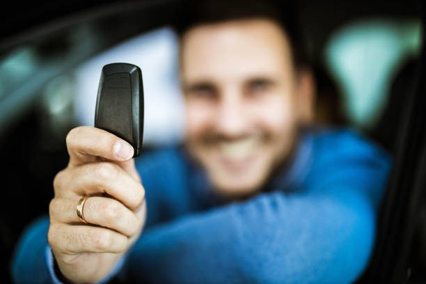 Close up of a man holding his new car key.