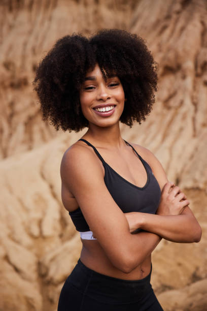 istock Smiling woman standing outdoors after a late afternoon trail run 1347431193