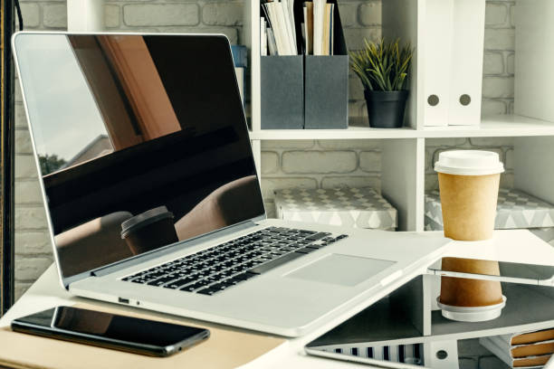 istock Laptop in a light room on working table with office supplies 1347431384