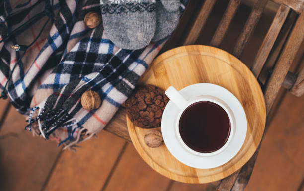 istock Tea and cookie with festive lights on terrace. 1347435603
