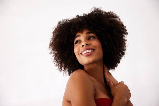 istock Smiling young woman looking over her shoulder on a white background 1347438920