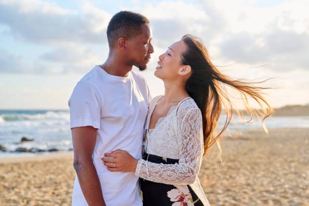 istock Loving romantic hugging young multiethnic couple on the seashore 1347441379