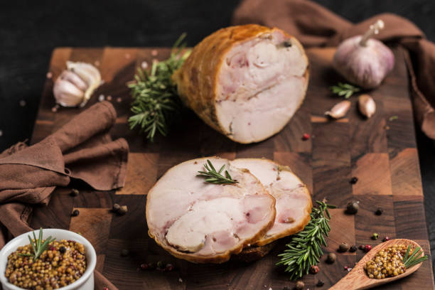 istock Chicken roulade is cut into two large pieces on a wooden board with fresh herbs 1347442078