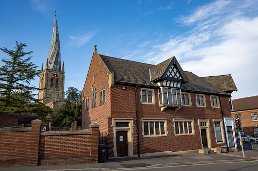 St Mary and All Saints Church in Chesterfield, England, with cars and people visible in the background