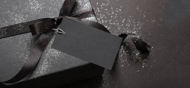 istock Black Friday sale concept, Gift box with ribbon bow on black background 1347444028
