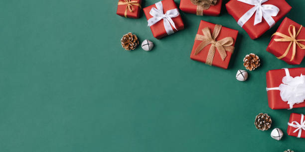 istock Gift boxes with white and brown bows on a green backdrop. 1347444434