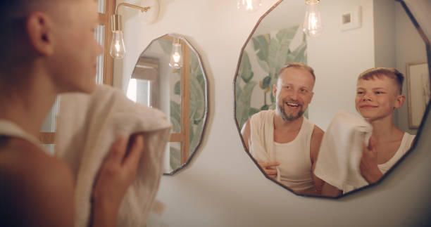 istock Father and son having fun shaving. Quality time with kid. Mirror reflection 1347445679