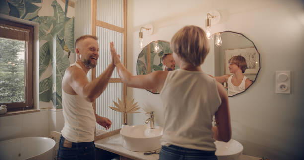 istock Father and son having fun shaving. Quality time with kid - high five 1347445755