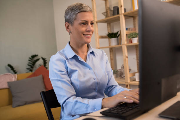 istock Happy woman working online from home 1347449390