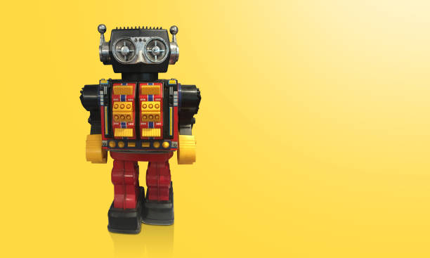 istock front view black and red robot toys standing on yellow background, object, gift, decoration, copy space 1347449979