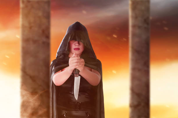 istock Asian witch woman with a cloak holding a knife standing 1347451341