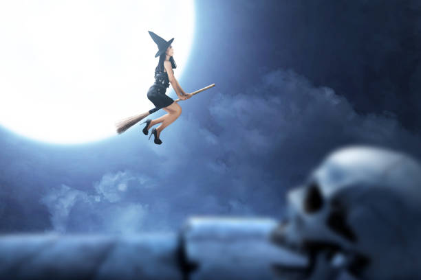 Asian witch woman with hat flying on a magic broomstick with a full moon background
