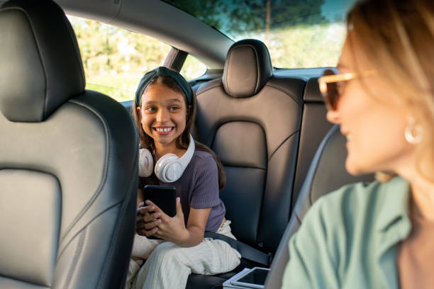 istock Happy daughter looking at her mom during chat inside car 1347452307