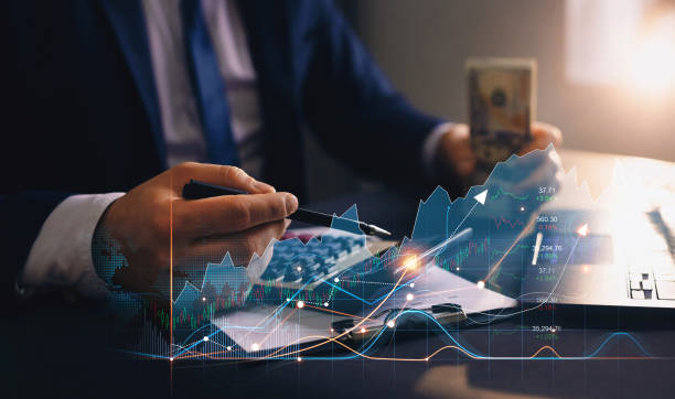 currency exchange, digital marketing, banking and stock concept. businessman using calculator and laptop to calculate the growth of finances and income from his successful business. - tax financial figures analyzing banking document imagens e fotografias de stock