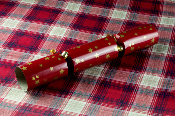 istock Red Christmas Cracker on a Tartan Table Cloth 1347457551
