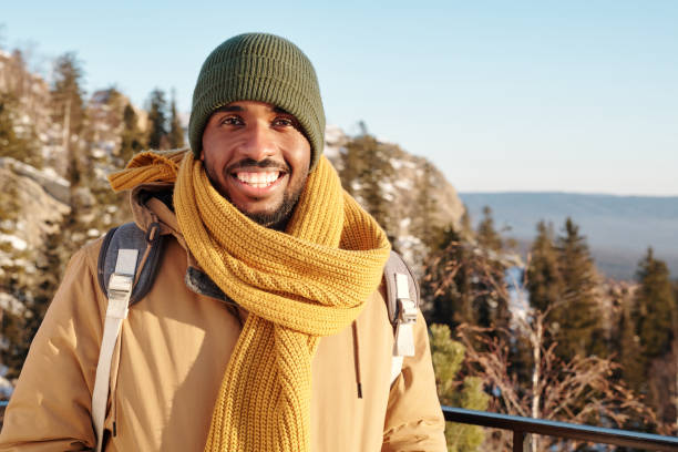 istock Young cheerful traveler with backpack enjoying winter adventure 1347458931