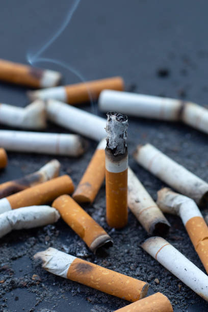 istock Ashtray and smoked cigarettes on dark background. 1347459661
