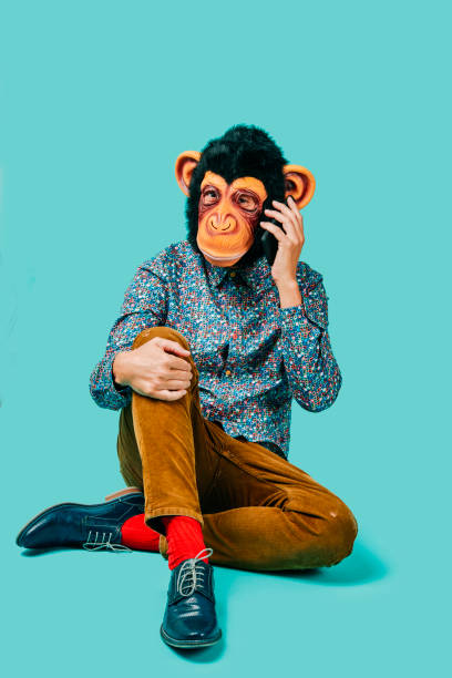 istock man with a monkey mask talks on the phone 1347462366
