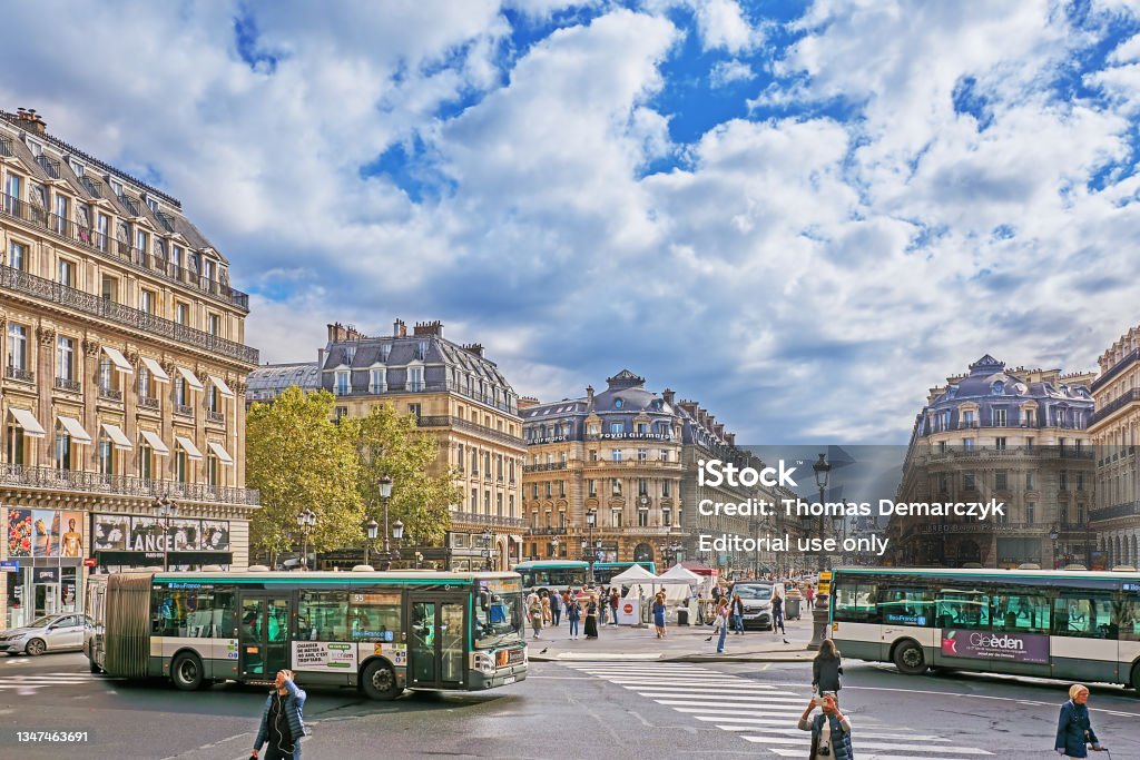 Paris Paris, France - September 27, 2021: Traffic and pedestrians on the Place de l`Opéra in front of the old opera, the Palais Garnier in Paris. Paris - France Stock Photo