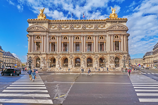 Paris, France - September 27, 2021: Traffic and pedestrians on the Place de l`Opéra in front of the old opera, the Palais Garnier in Paris.